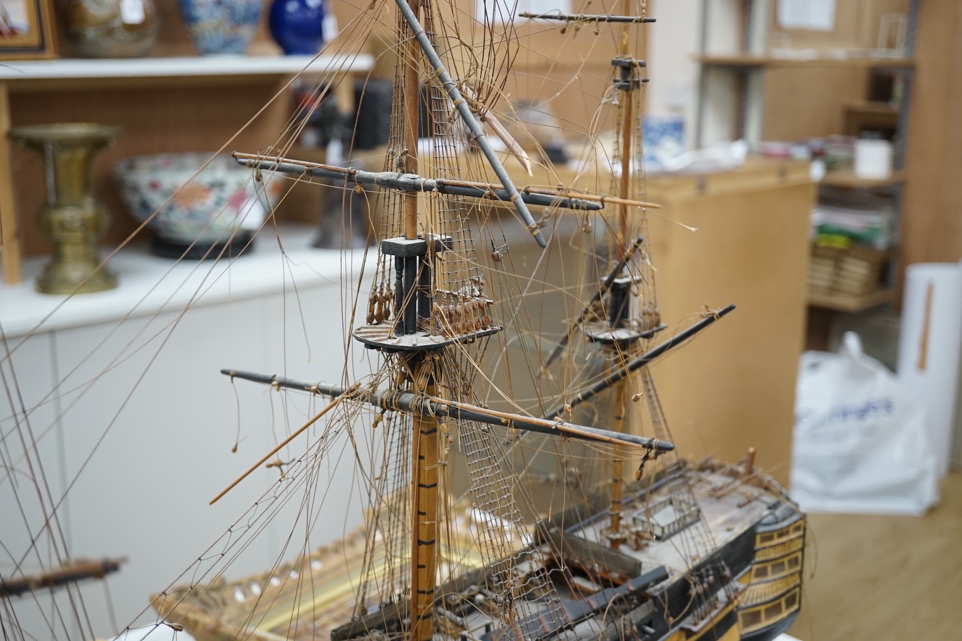 A large model of a rigged ship, 84cm long. Condition - fair